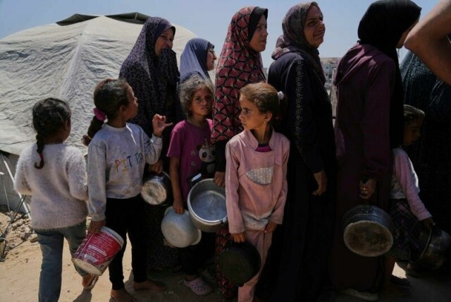 Palestinske kvinner og barn venter på å få utdelt matrasjoner i en teltleir i Gaza by på dette bildet tatt onsdag.