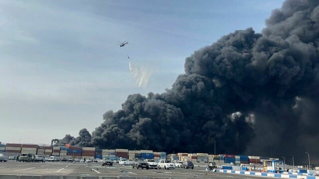 Et helikopter bisto i slukkingen av brannen tidligere lørdag mens en voldsom røyksky veltet opp fra åstedet.