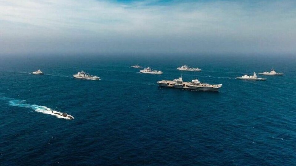 Det er det britiske hangarskipet HMS Prince of Wales som leder gruppen. Hangarskipet er det største skipet på bildet. Det er det britiske hangarskipet HMS Prince of Wales som leder gruppen. Hangarskipet er det største skipet på bildet. Foto: Den britiske marinen