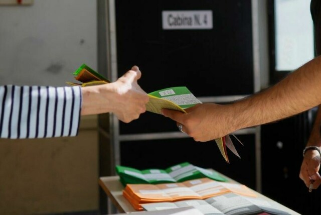 En italiener mottar valgskjemaet til folkeavstemningen som avholdes søndag og mandag.