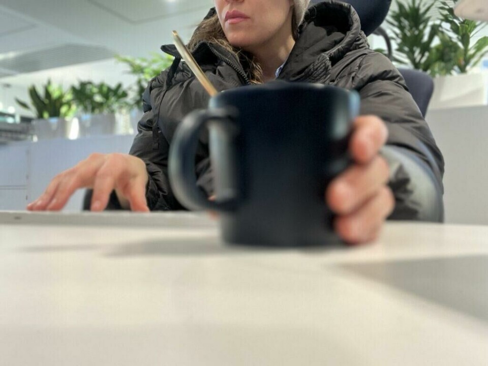 Birketvedt forteller at det å fryse kan påvirke mer enn bare komforten. Kulde kan redusere fingerferdighet og kognitiv funksjon, produktivitet, gjøre det vanskeligere å konsentrere seg og påvirke mental ytelse. (Foto: Cecilie Aasland / ABC Startsiden) 'Hvorfor fryser noen mennesker mer enn andre – Bildet viser en person kledd i tykk dunjakke og lue mens de sitter innendørs med en kopp varm drikke, noe som indikerer at de føler seg kalde selv i innemiljø. Med fokus på faktorer som kroppstemperaturregulering, stoffskifte og blodomløp kan dette illustrere hvorfor enkelte mennesker trenger ekstra varme klær, selv innendørs. Perfekt for artikler om forskjeller i kuldefølelse, tips for å holde seg varm og årsaker til at noen fryser lettere enn andre.'