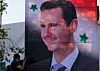 Banner med bilde av Syrias president Bashar al-Assad. Hovedstaden Damaskus 27. juni 2018. Scanpix/AFP.