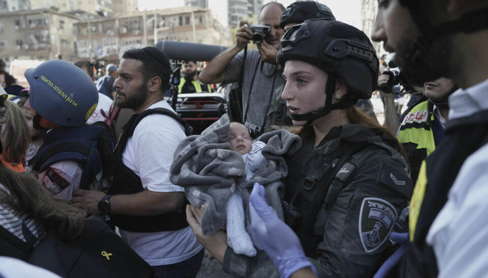 En baby evakueres fra åstedet for et iransk rakettangrep i Ramat Gan i Israel.