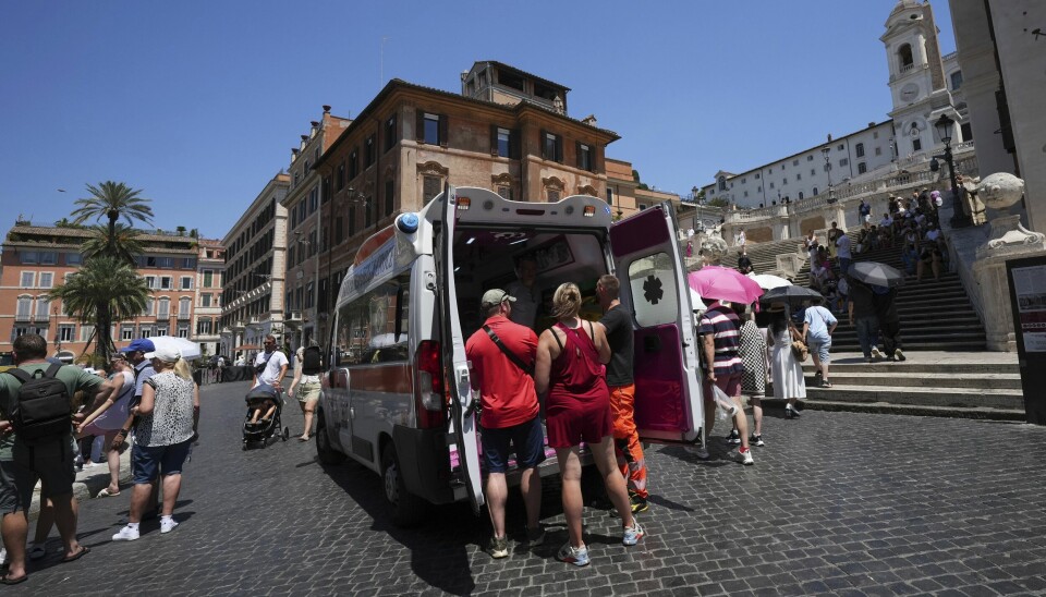 Ambulansearbeidere hjelper turister i varmen i Roma.