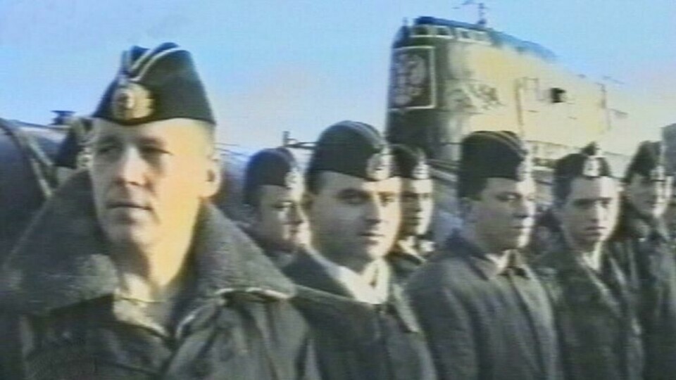 Mannskapet ble avbildet før de dro ut på tokt i ubåten Kursk sommeren 2000. De kom aldri tilbake. I bakgrunn ser man den atomdrevne ubåten. Mannskapet ble avbildet før de dro ut på tokt i ubåten Kursk sommeren 2000. De kom aldri tilbake. I bakgrunn ser man den atomdrevne ubåten. Foto: NTV/AP/NTB