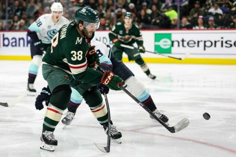Minnesota Wilds høyreving Ryan Hartman (38) skyter pucken mens Seattle Krakens back Cale Fleury (8) forsvarer i tredje periode av NHL-kampen i St. Paul, Minnesota onsdag.