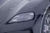Frontlykt og felg på svart Porsche dekket av lette snøfnugg. Lyktene med LED-Matrix og kjørelys med fire punkter har sort innfatning.