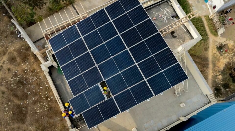 Arbeidere i gang med å legge solceller på taket av et boligbygg i utkanten av New Delhi i India i februar. Landet trenger svært store investeringer hvis utviklingen med stigende klimautslipp skal snus. Foto: Manish Swarup / AP / NTB