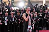 Renate Reinsve poserer og hilser foran et hav av fotografer på rød løper i Cannes.