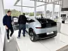 Hyundai Ioniq-elbil utstilt innendørs mens flere personer ser inn i bilen.