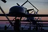 Rekke med ukrainske militærdroner på rullebane ved solnedgang.