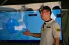Mexican Army officer stands beside a large screen showing maps and drone-related tactical information.