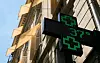 Et grønt digitalt apoteksskilt viser 37 grader Celsius på en bygning i Paris.