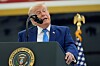Donald Trump taler ved en talerstol med presidentseglet foran et amerikansk flagg.