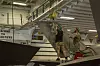 To mekanikere bruker sele for å løfte halepartiet på et F-35B-fly om bord på USS Makin Island.