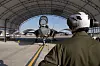 Marine mechanic inspecting an F-35B fighter jet under a hangar roof at MCAS Cherry Point.