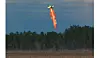 GBU-43/B-bombe faller loddrett over et skogbelte under test i 2003.