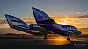 Fly med teksten «GALACTIC» på rullebane i solnedgang.