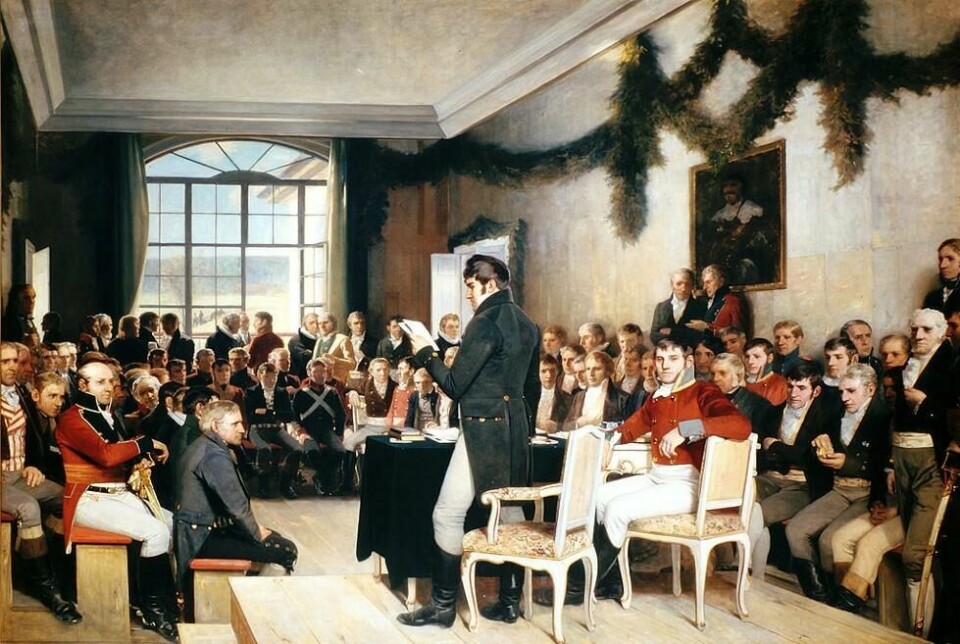 «Eidsvoll riksraad 1814» av Oscar Arnold Wergeland, Stortingsarkivet. Motivet syner Christian Magnus Falsen, som les frå Grunnlova. Lisensiert under Offentlig eiendom via Wikimedia Commons. «Eidsvoll riksraad 1814» av Oscar Arnold Wergeland, Stortingsarkivet. Motivet syner Christian Magnus Falsen, som les frå Grunnlova. Lisensiert under Offentlig eiendom via Wikimedia Commons.