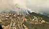 Store områder er røyklagt, etter at i alt 14 skogbranner har rammet vindistriktet i California. Foto: Handout / Reuters