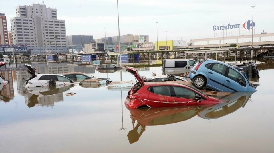 Biler delvis dekket av flomvann i Valencia i Spania fredag. Foto: Alberto Saiz / AP / NTB