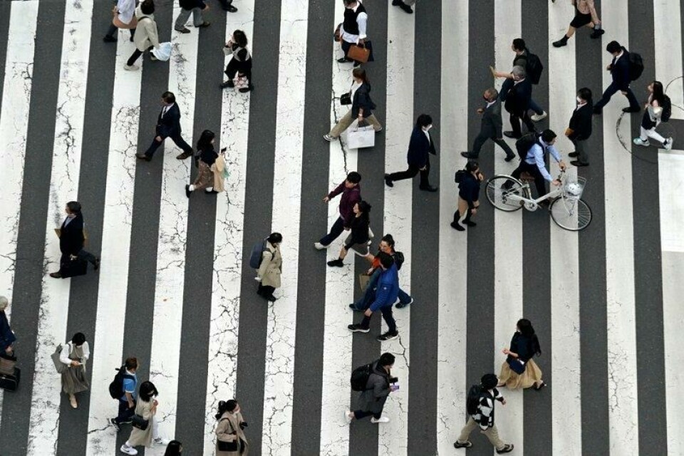 Inflasjonen i Japan er på vei opp. Bildet viser folk som går over et fotgjengerfelt i shoppingdistriktet Ginza i Tokyo.
