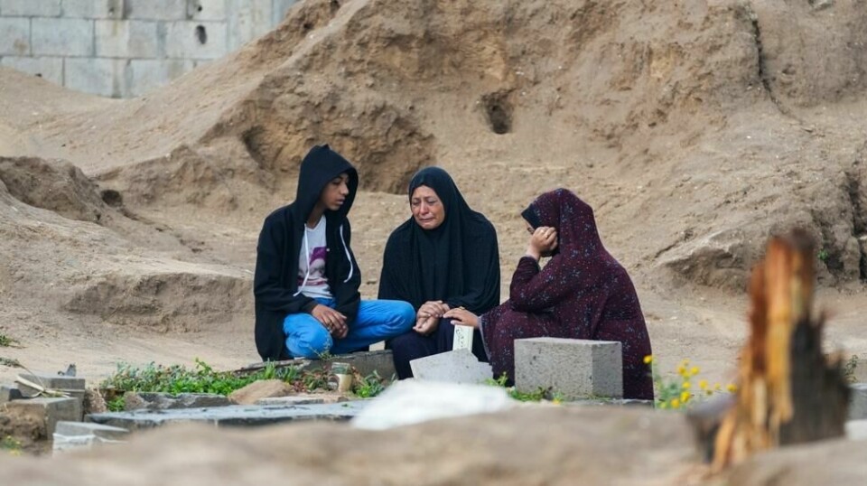 En palestinsk familie besøker graven til en slektning på den første dagen av den muslimske høytiden id al-fitr. Foto: Abdel Kareem Hana / AP / NTB