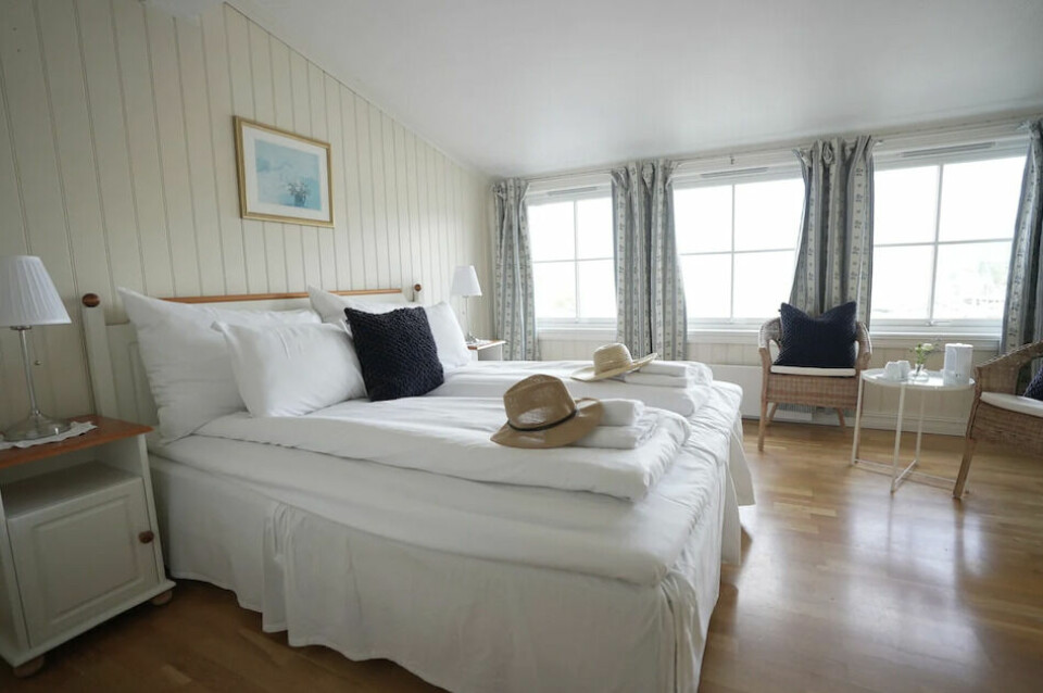 Sjarmerende rom med utsikt mot havet. Dobbeltseng på hotellrom på badehotell i Holmsbu.